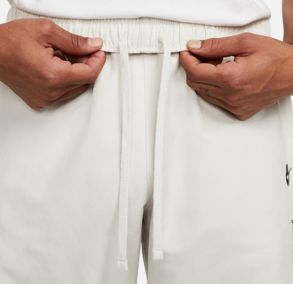 Jasnoszare Spodnie Męskie Nike Sportswear Repeat DX2033-072 r. XS